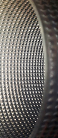 Close-up of a refurbished front-load washing machine drum shining after thorough cleaning and overhaul.
