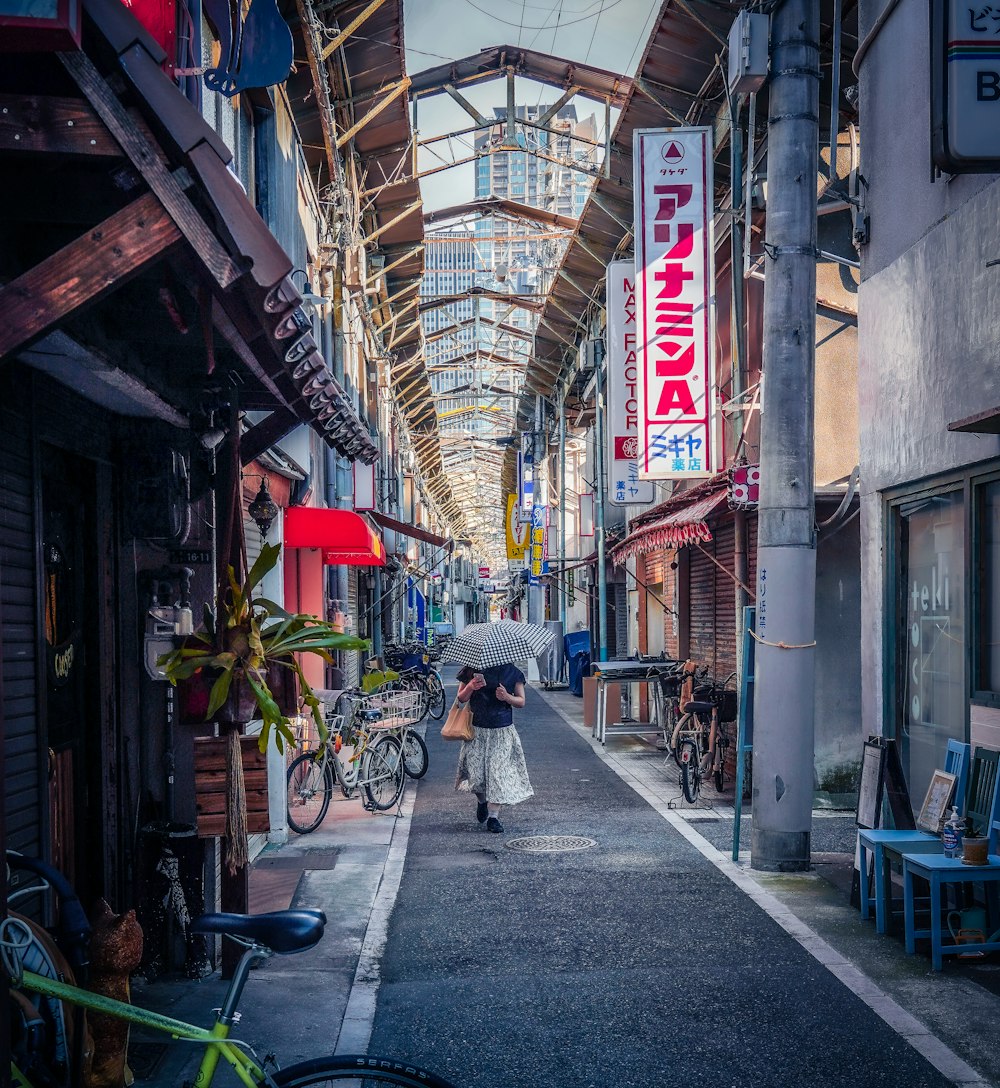 a person walking down a street with an umbrella