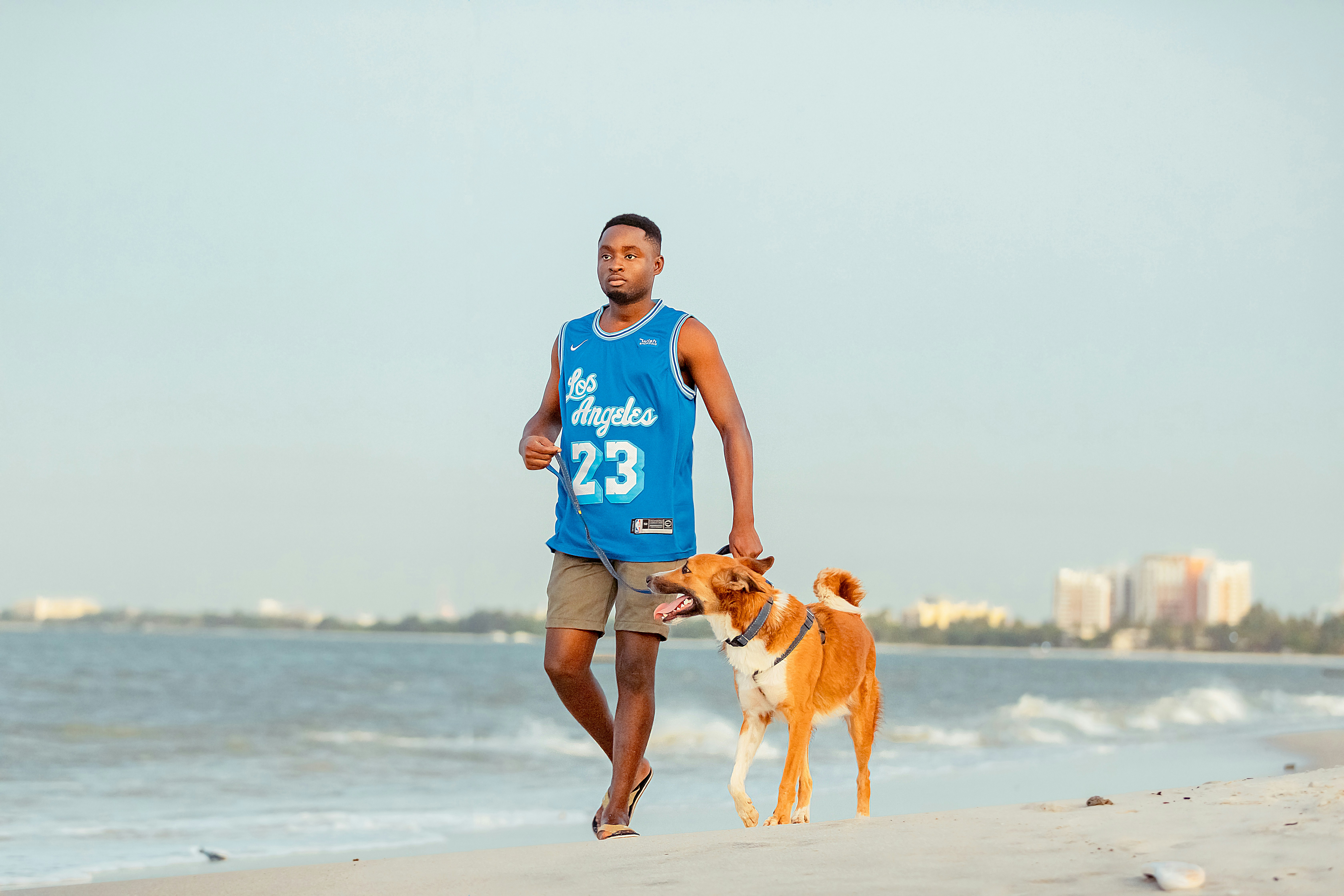 Man running with a dog along the beach
