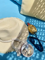 SunZapper products displayed on a wooden table with beach accessories like sunglasses and a hat