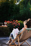 a person sitting in a chair reading a book