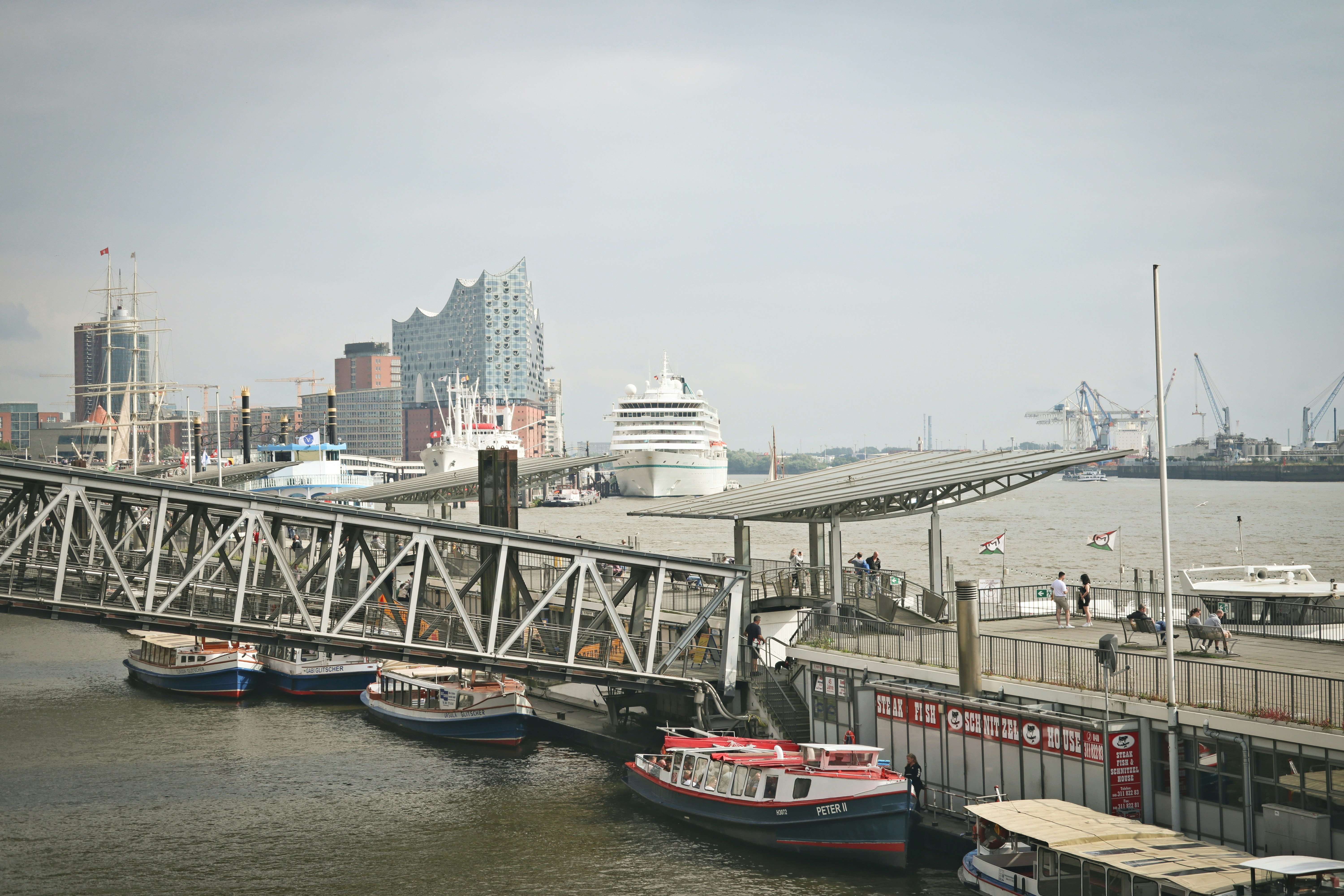 a bridge over a body of water with boats on it