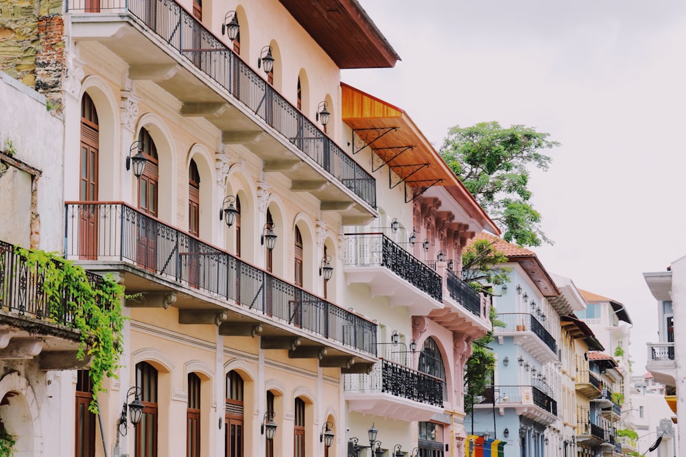 a row of buildings with balconies and trees