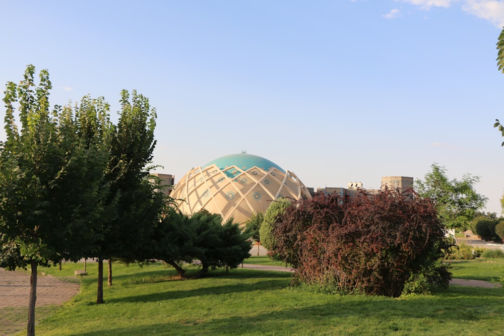 a large sphere shaped building surrounded by trees