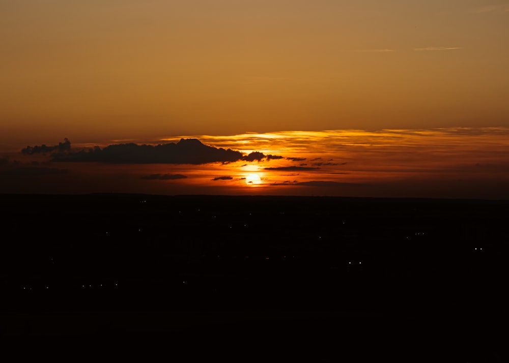 a sunset over a large flat area