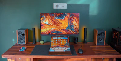 Vibrant computer setup with colorful accessories and large bold text overlay.