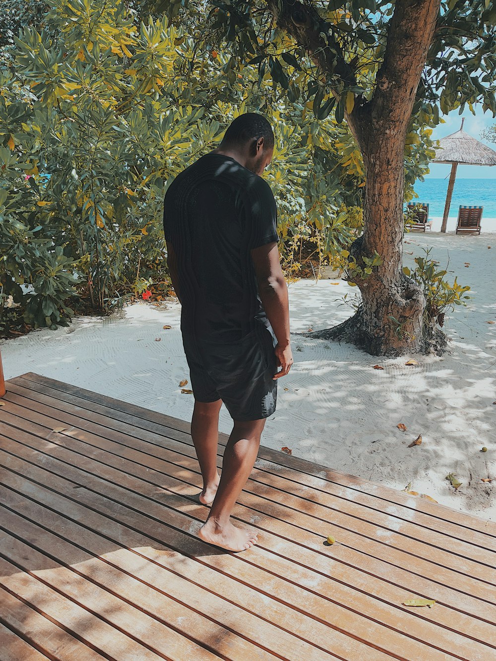 a man walking on a wooden deck