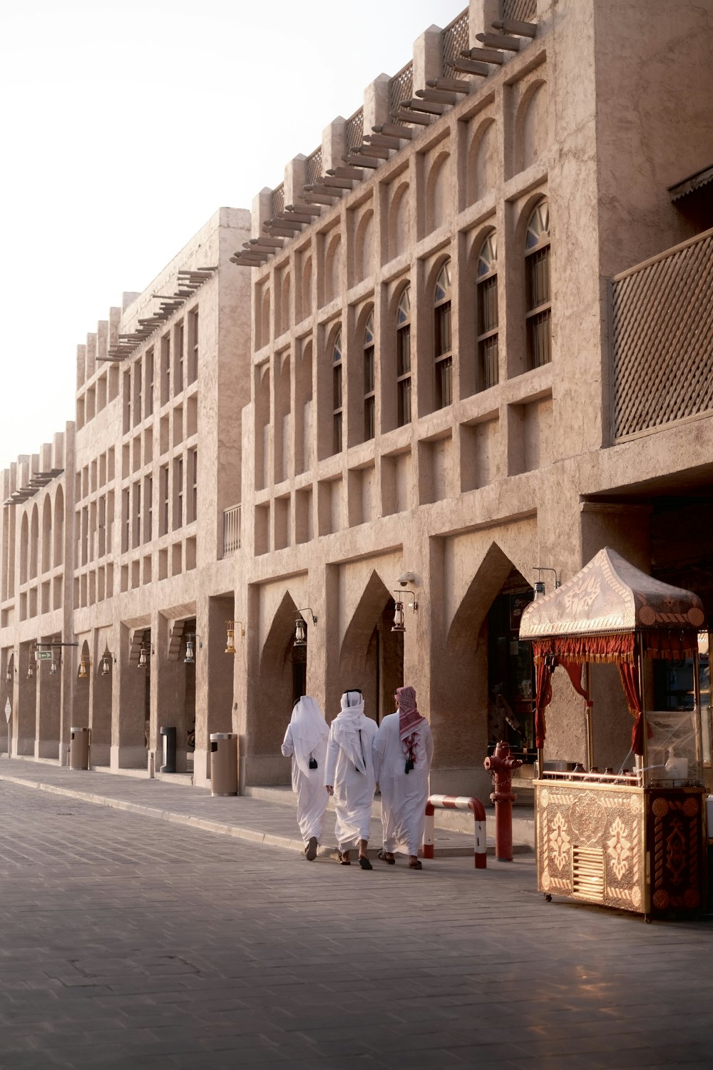 a person walking down a street next to a building