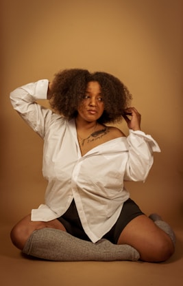 an African-American women with knee high compression sox sitting on the floor
