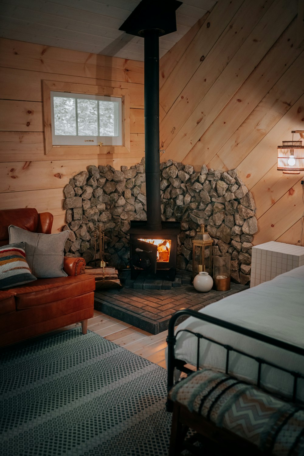 a living room with a bed and a fireplace