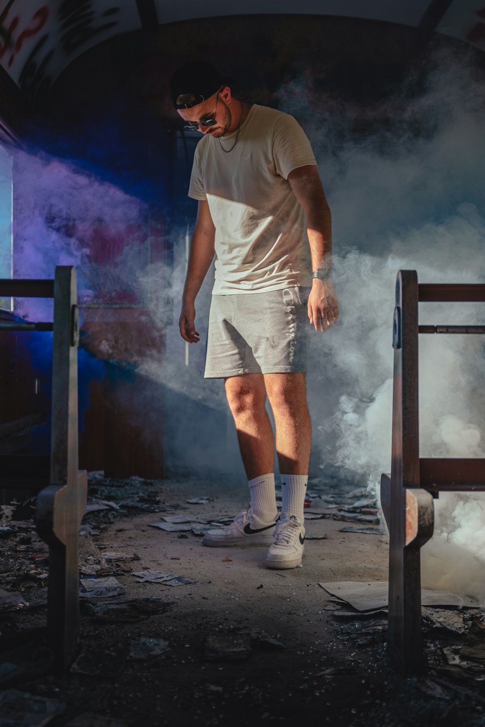 a man standing in front of a wall with smoke coming out of it