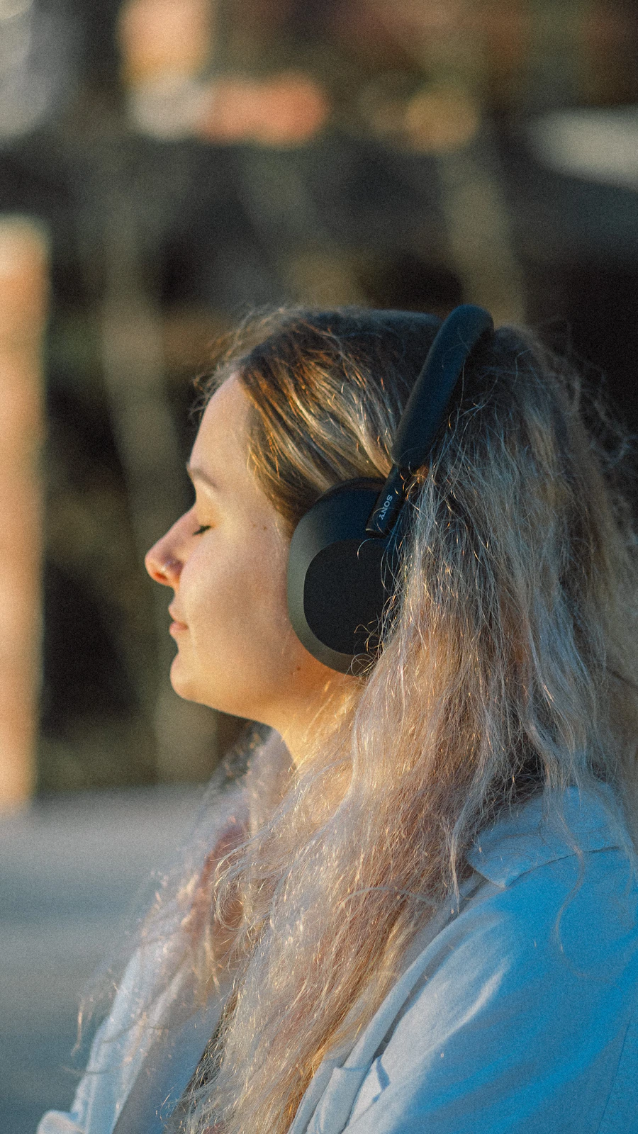 Woman wearing headphones in a relaxed setting