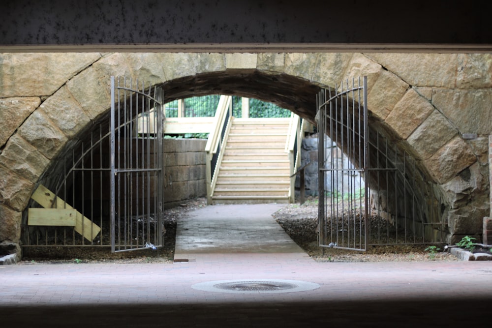 a stone tunnel with a gate