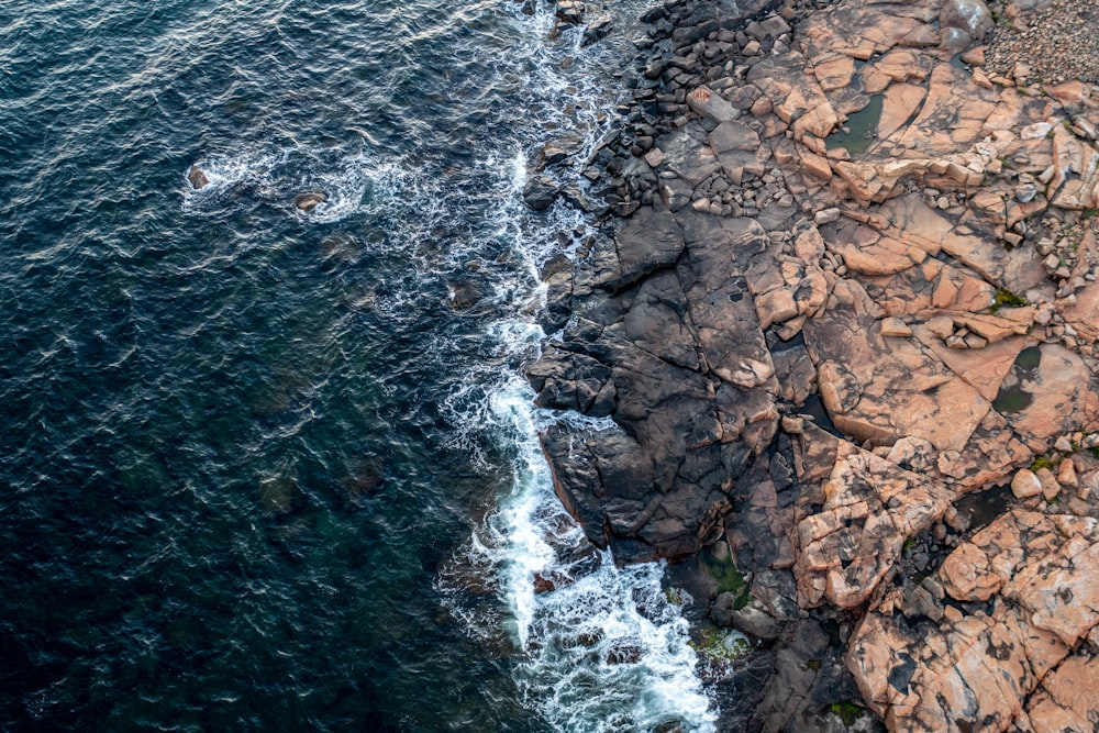 a rocky shore with a body of water and a rocky shore