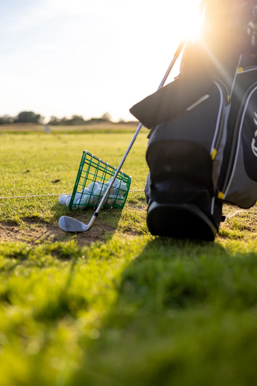 A basket of range balls on the grass