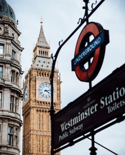 a clock tower next to a sign