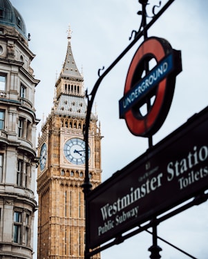 a clock tower next to a sign
