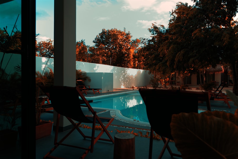 a pool with chairs around it