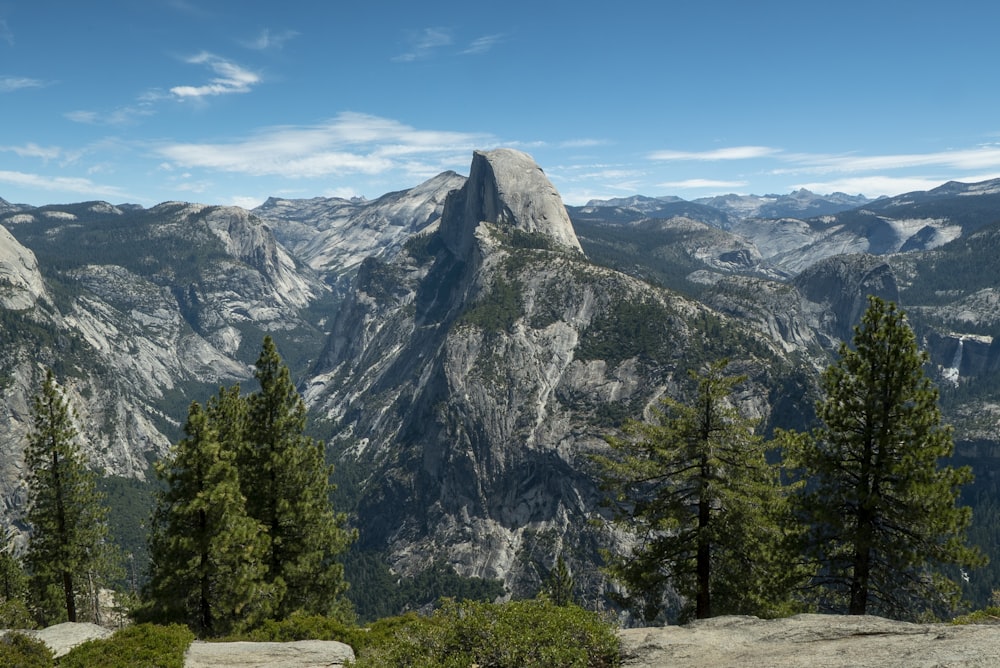 a mountain with trees and mountains in the background