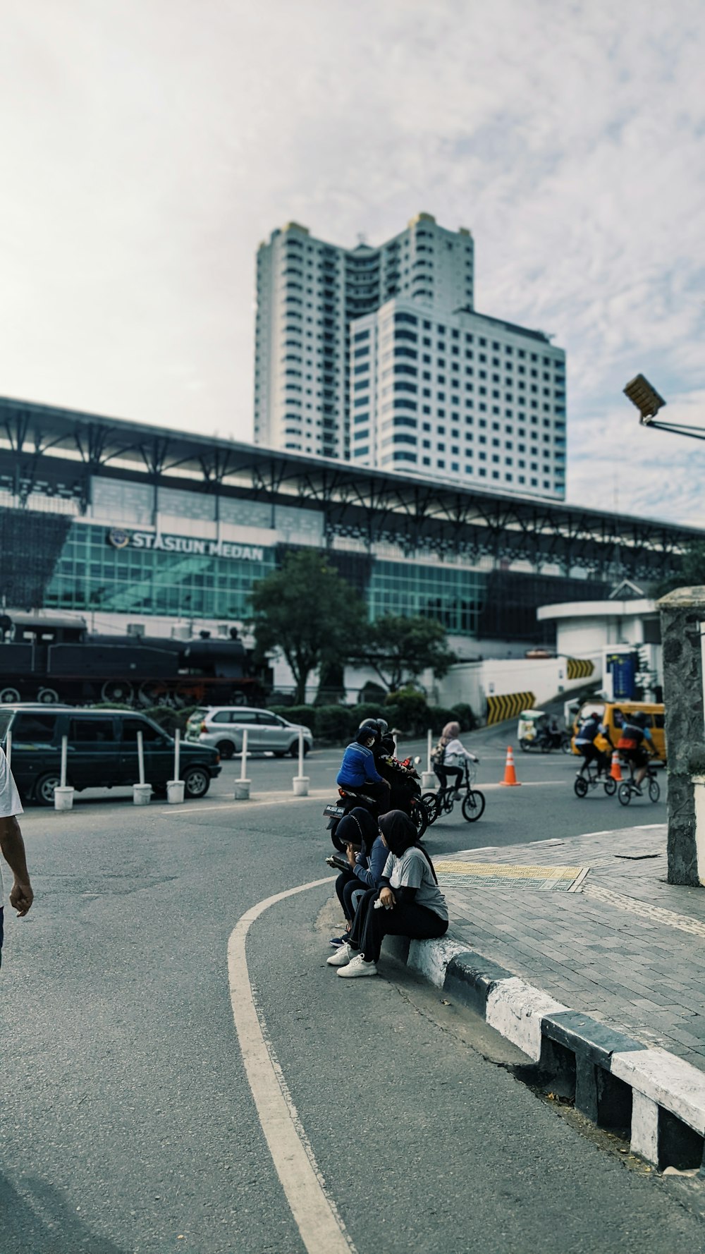 a group of people riding bikes on a street