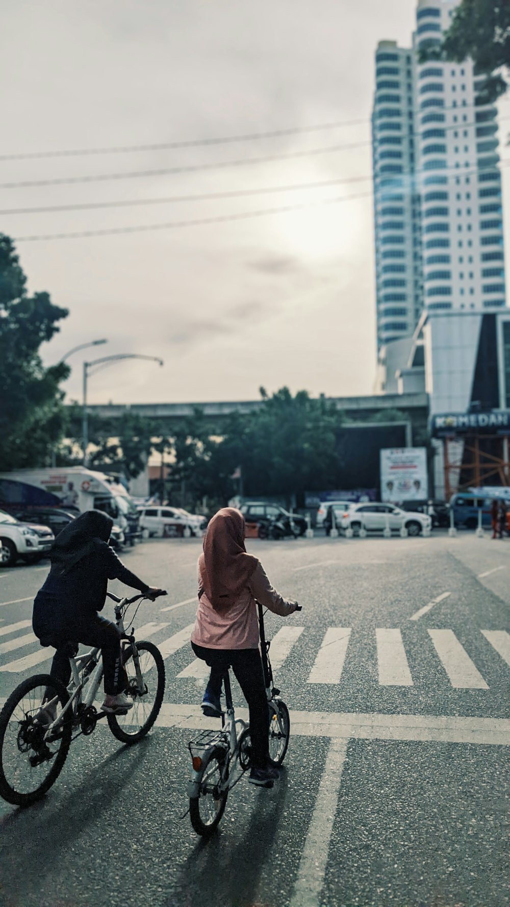 um casal de pessoas andando de bicicleta em uma rua