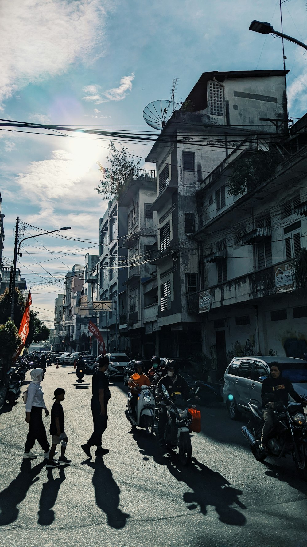 a group of people walk down a street