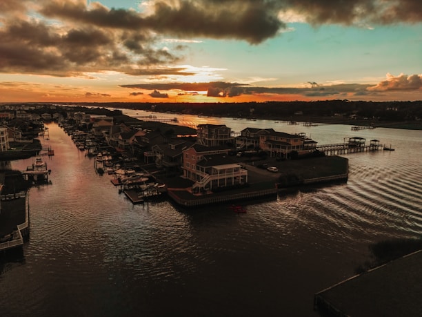 A peaceful view of Fairfield Harbour's waterfront homes at sunset.