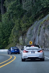 Dynamic shot of a BMW M2 speeding on a winding mountain road.