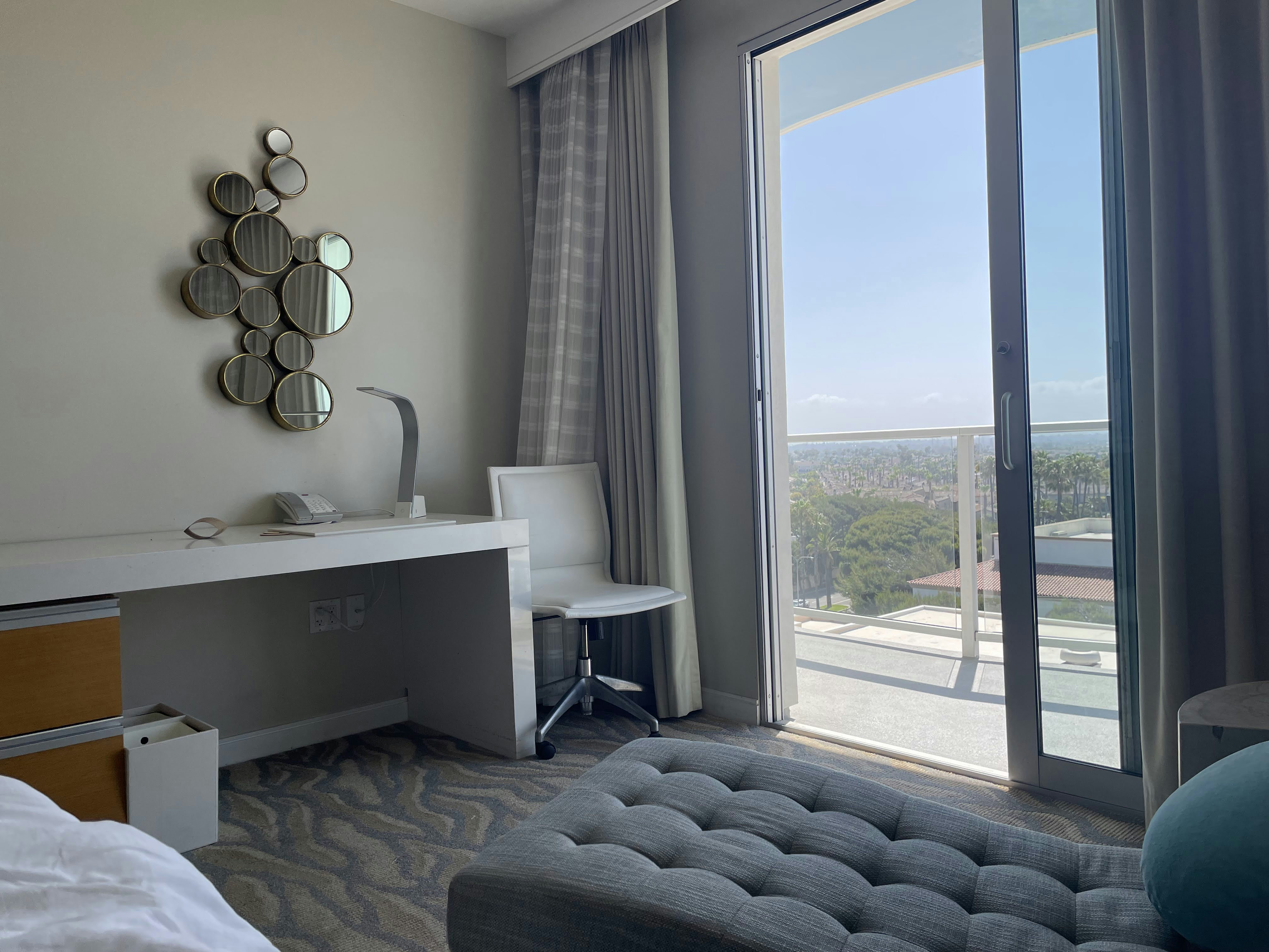 Modern room featuring stylish decor and a small workspace with a city view.