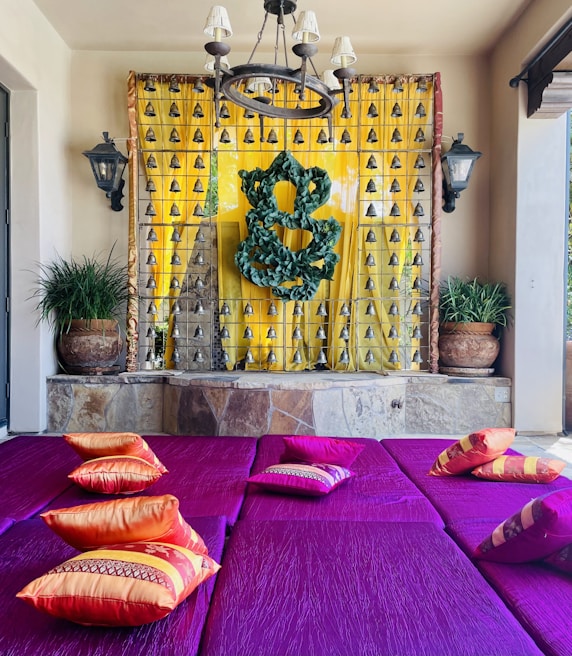 a room with a fireplace and a colorful couch