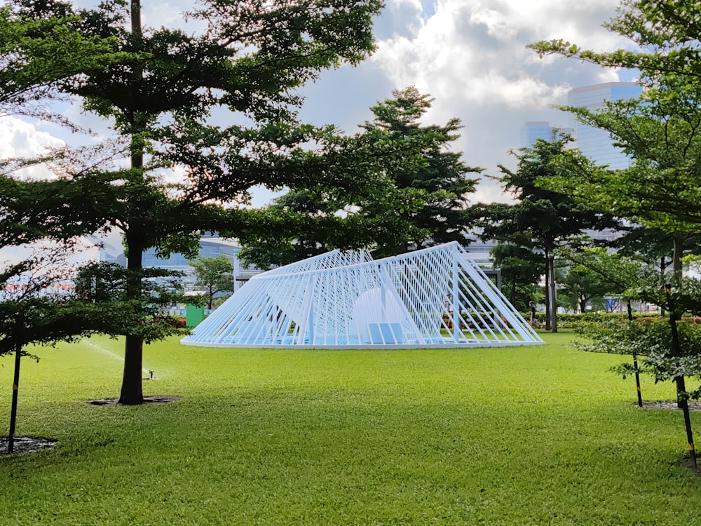 a large white tent in a park