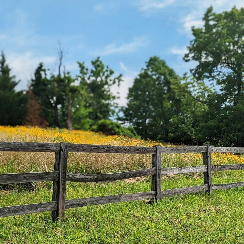a wooden fence in a field