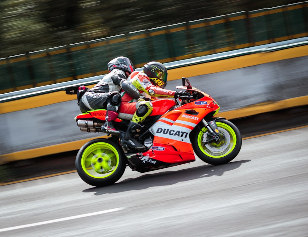 a couple of people racing on a motorcycle