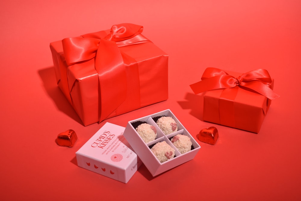 a red background with a box of food and a red bag with a red background