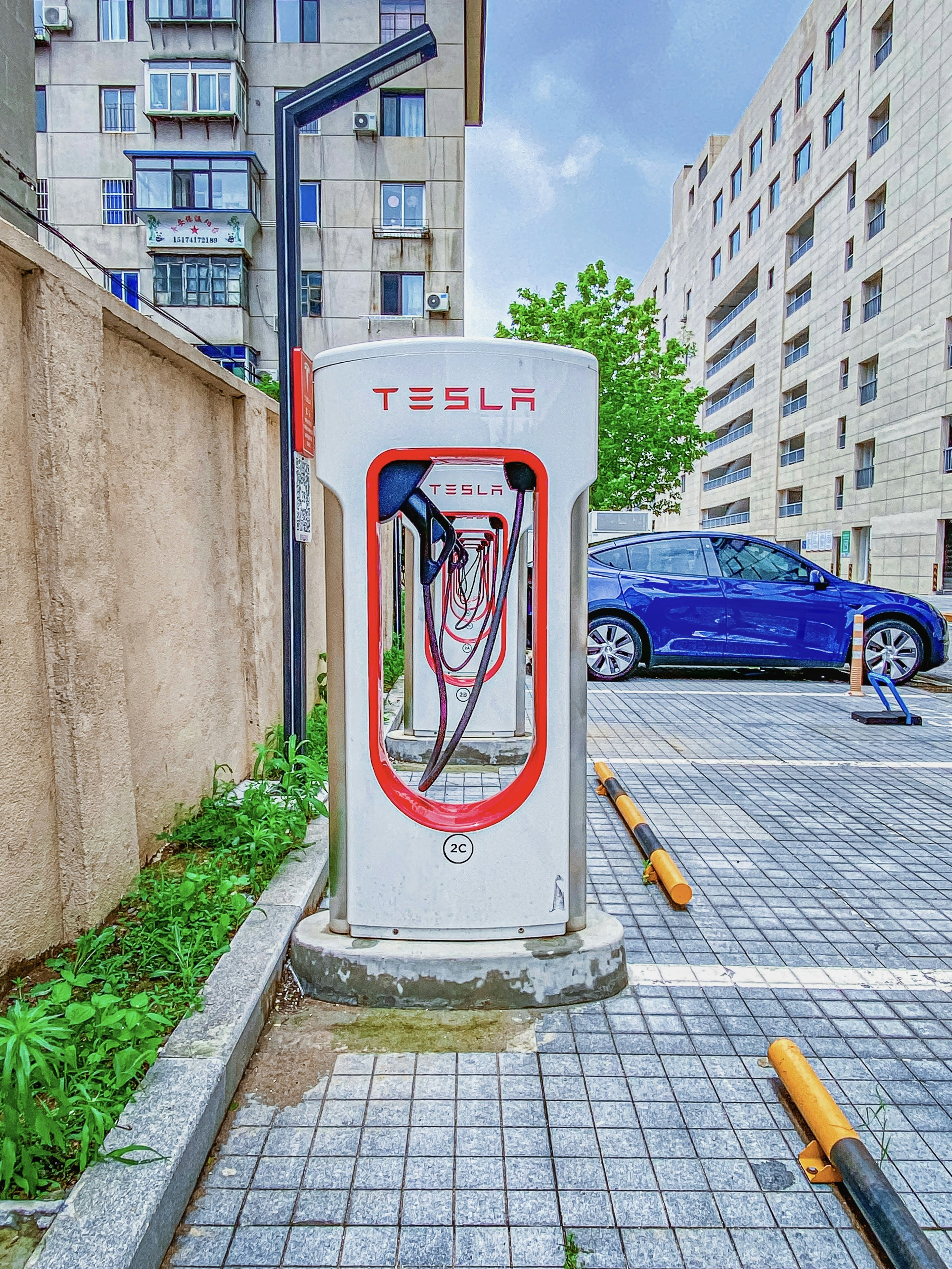 a red and white box on a sidewalk