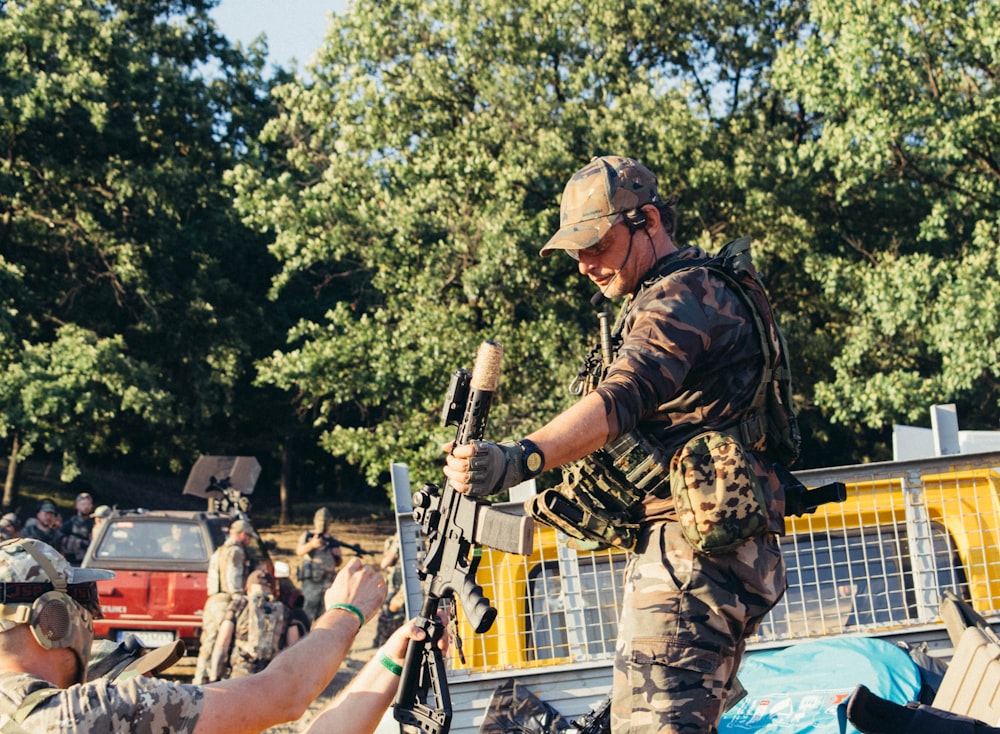 a man in military uniform holding a gun