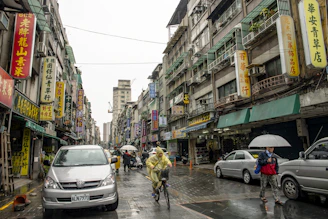 a person riding a bicycle down a busy street