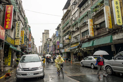 a person riding a bicycle down a busy street