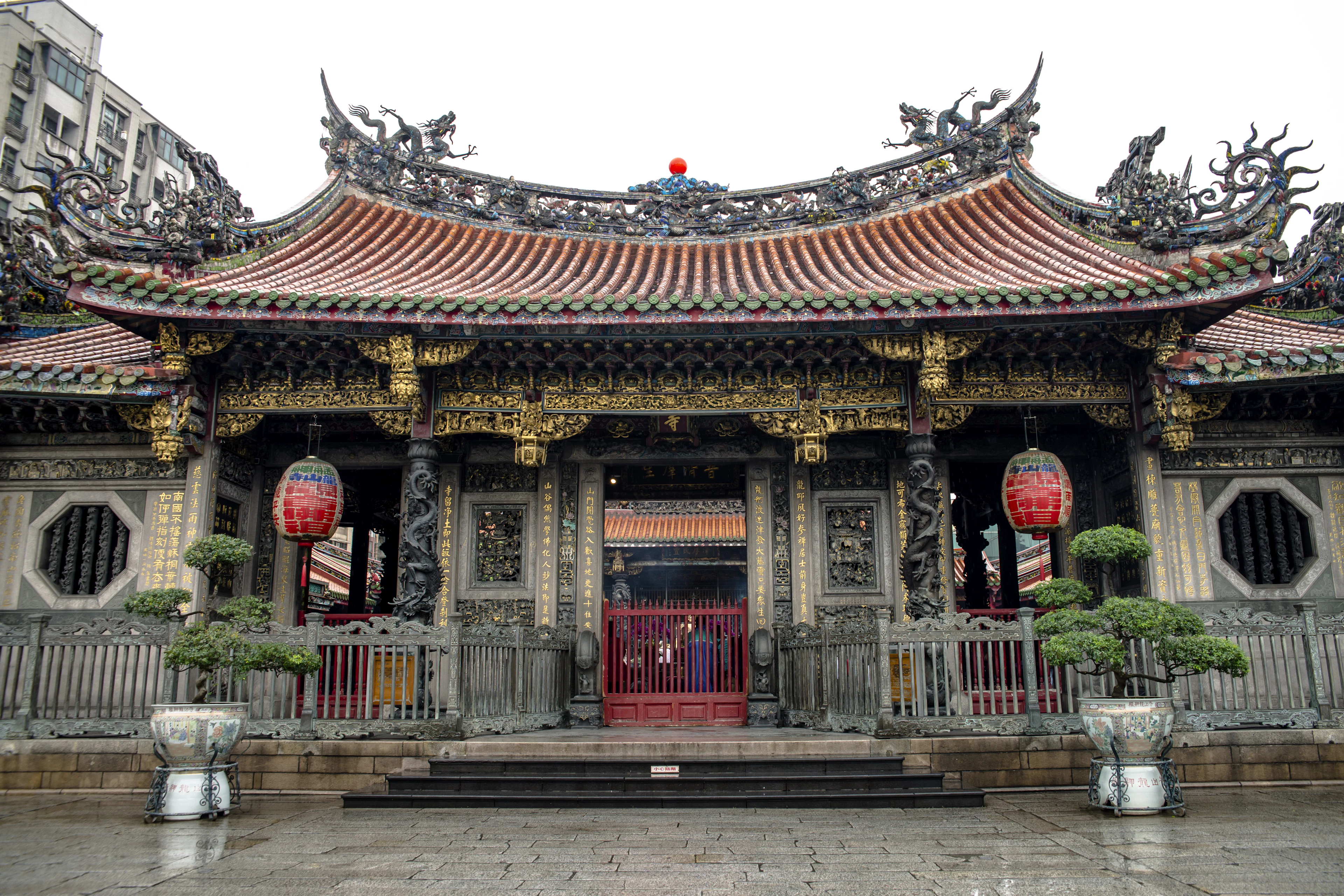 Longshan Temple in Taipei, dragons worked along the ridge of its swept tiled roof