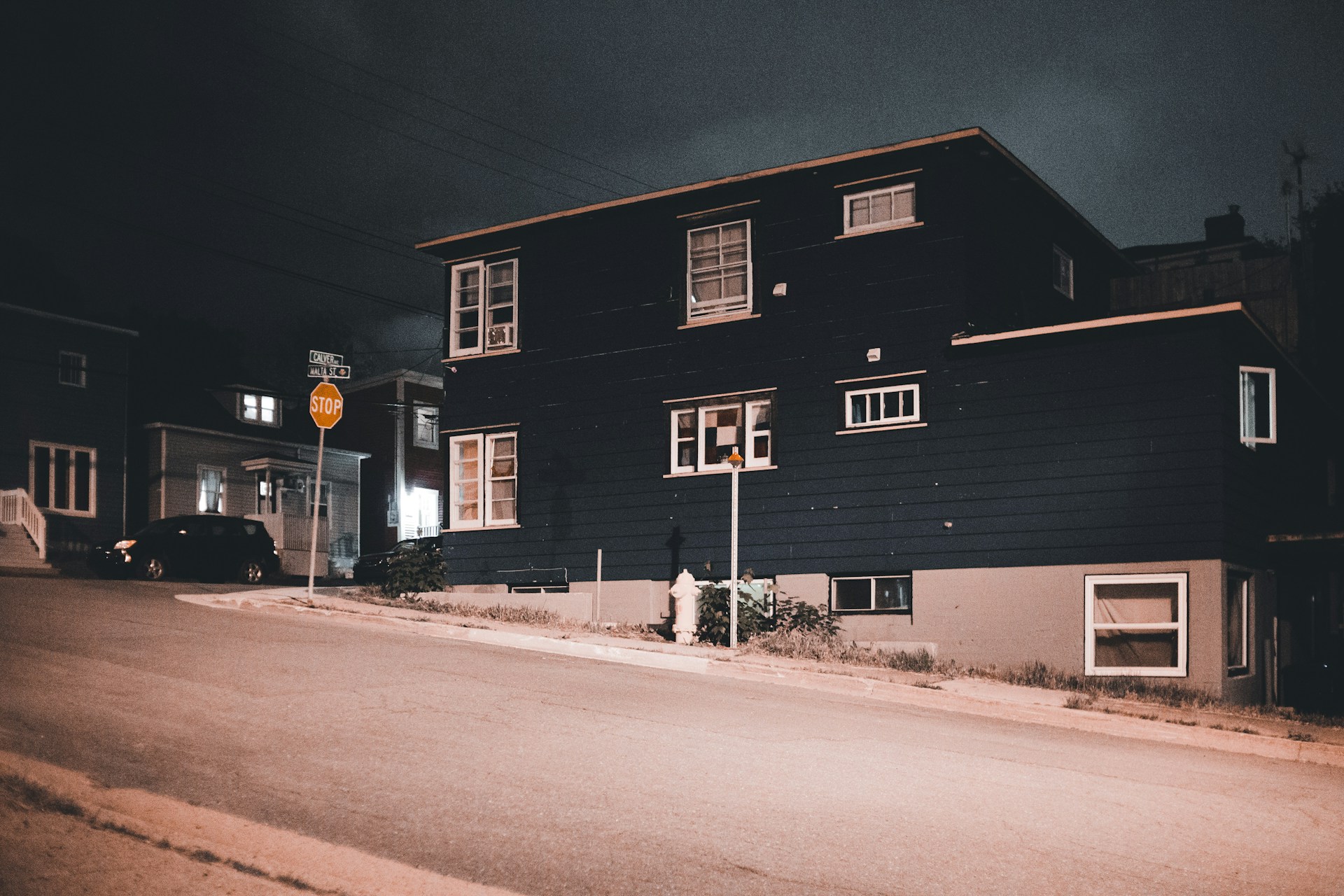 a black house on a street