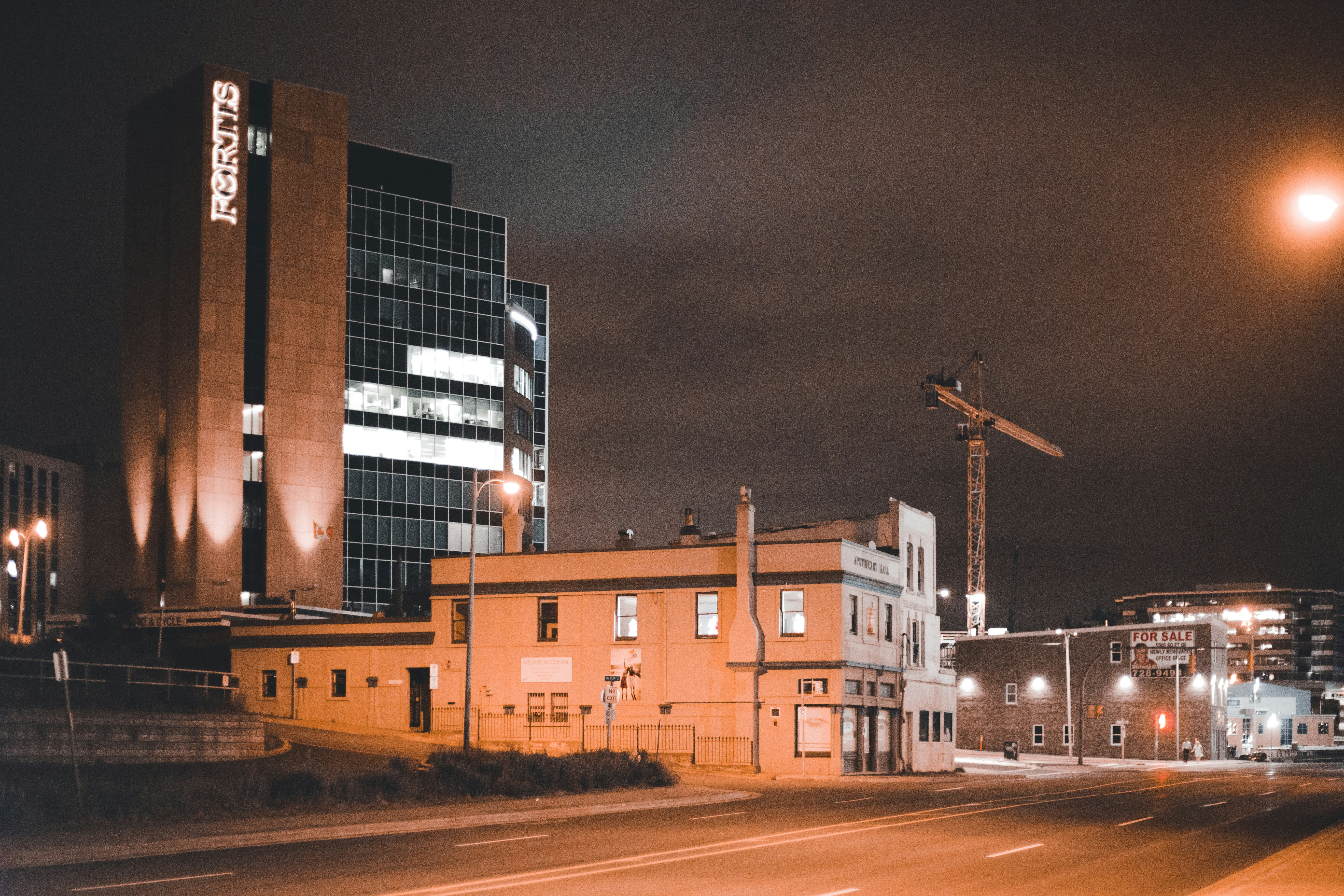a street with buildings and cranes