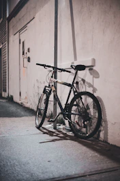 a bicycle parked against a wall