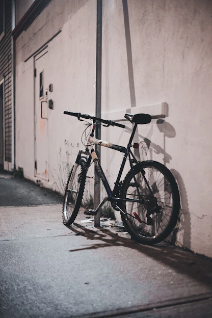a bicycle parked against a wall