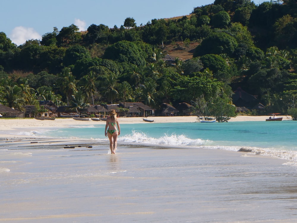 a person in a garment walking on a beach