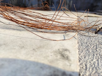 Close-up of copper wire bundles ready for recycling on a wooden surface.