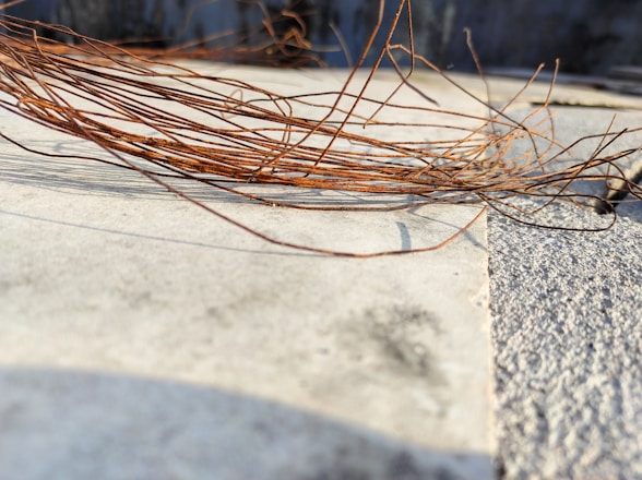 Close-up of copper wire bundles ready for recycling on a wooden surface.