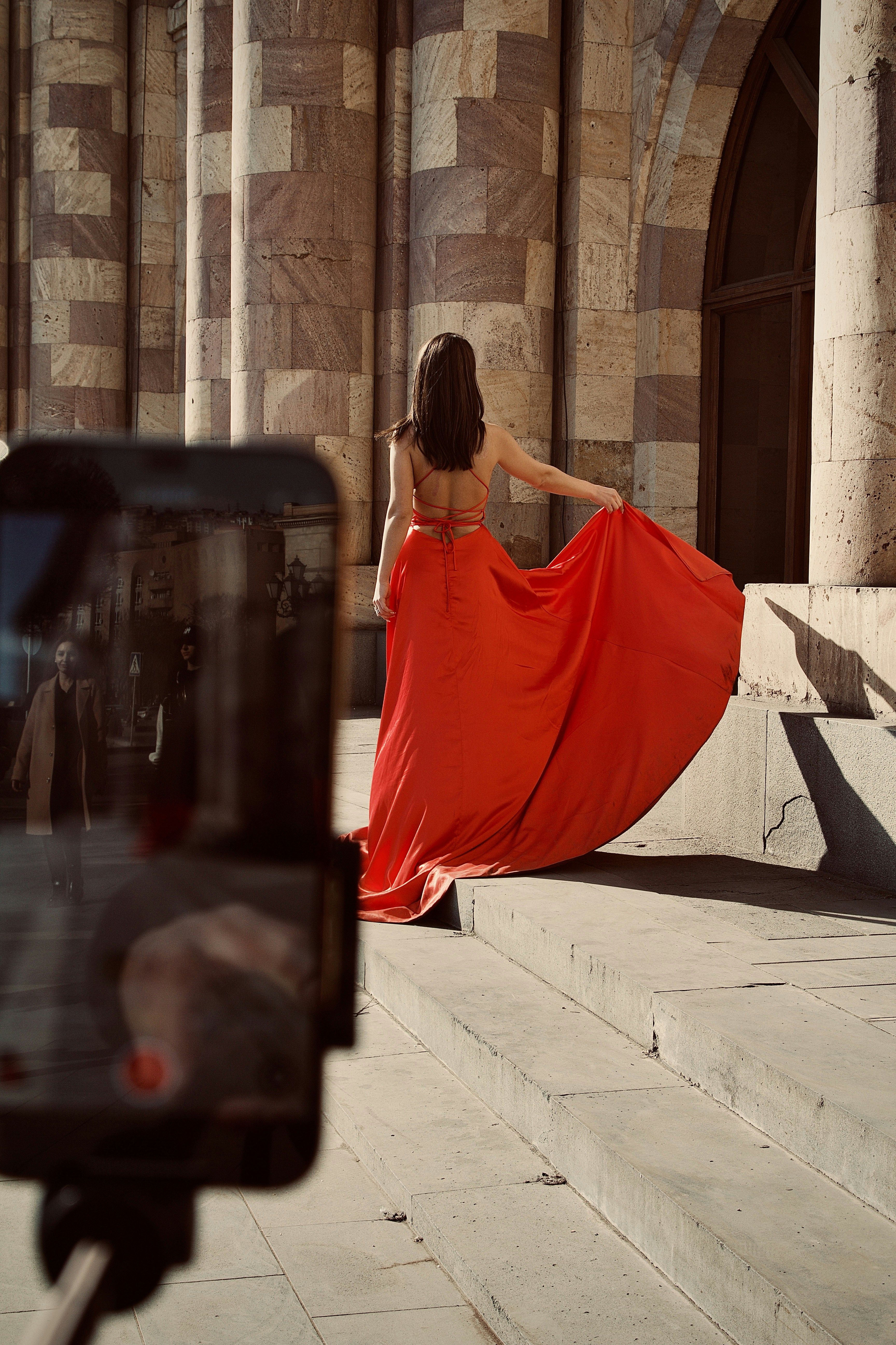 a person in a dress walking down a street
