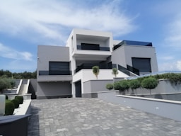 a white house with a stone patio