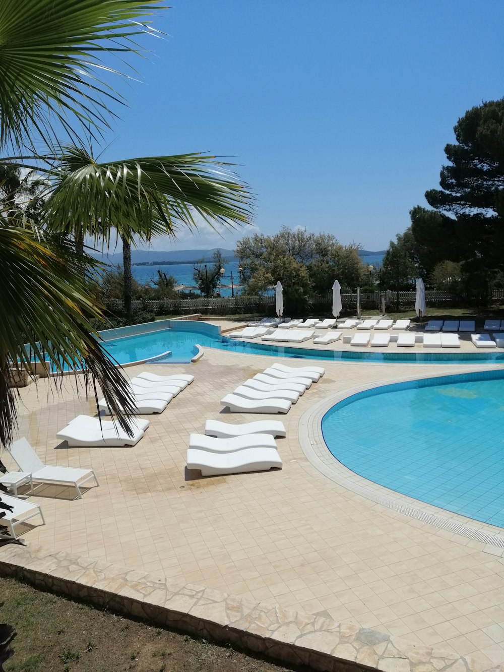 a swimming pool with lounge chairs