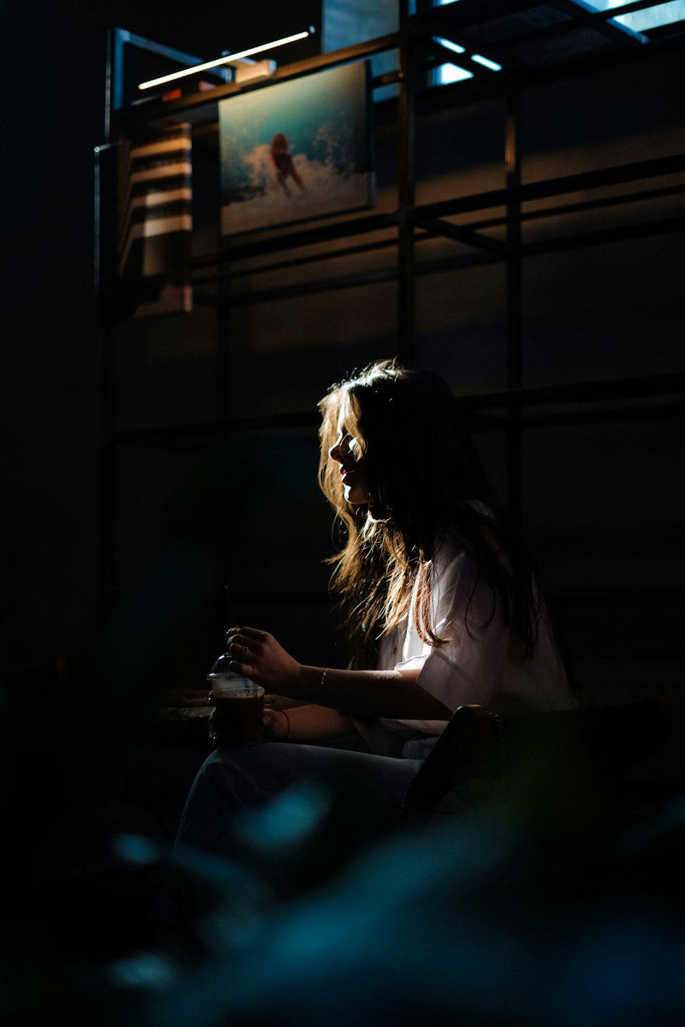 a woman sitting in a dark room